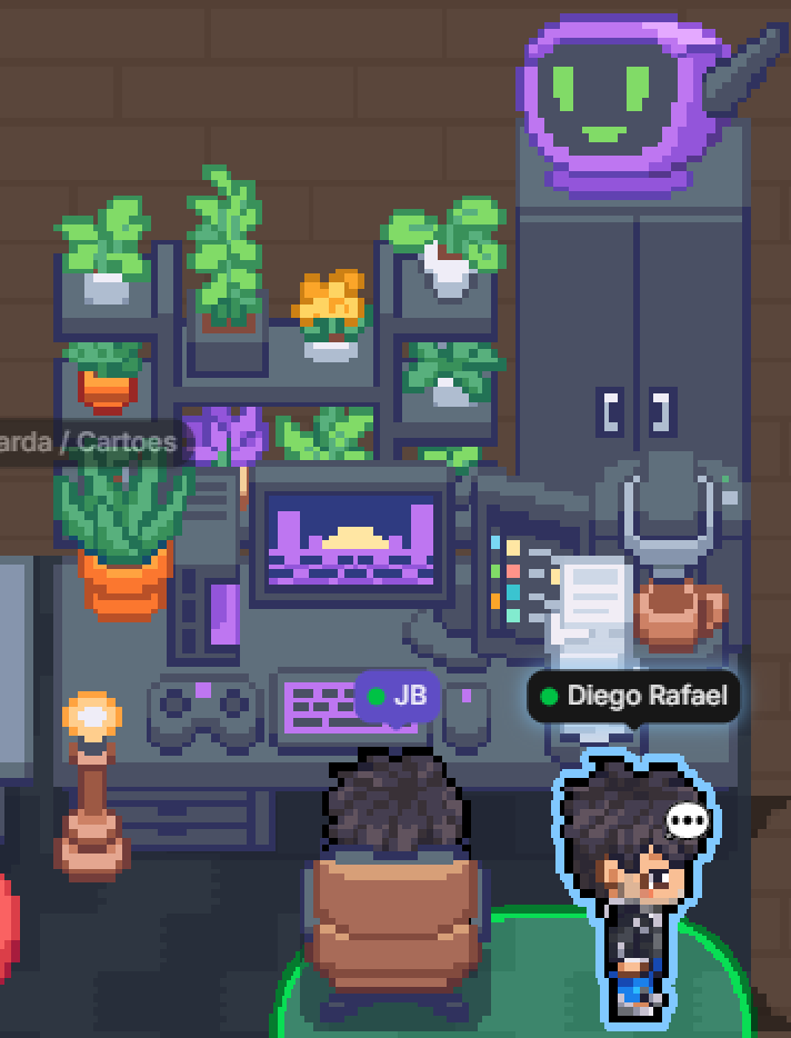 A desk in a Gather office: shelves of plants, a monitor and keyboard, a lit lamp, a tray of papers, and a status monitor showing a smiling face.